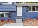 Front entrance with steps leading to a newly painted blue home at 1730 Salina Dr, Jonesboro, GA 30236