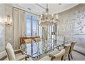 Formal dining room featuring a glass table, chandelier, and wallcovering at 3376 Peachtree Ne Rd # 47A, Atlanta, GA 30326