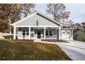 Gray house with white columns, front porch, and a two-car garage at 5359 Megan Rd, Stone Mountain, GA 30088