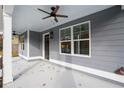 Front porch detail with ceiling fan and gray siding at 5359 Megan Rd, Stone Mountain, GA 30088