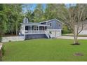 Two-story house featuring a white porch, attached garage, and a well-maintained lawn at 3665 Sharon Dr, Powder Springs, GA 30127