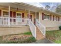 Charming front porch with white railings and steps at 1481 Estes Rd, Rutledge, GA 30663