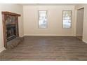 Spacious living room featuring hardwood floors and a stone fireplace at 608 Woodknoll Ct, Jonesboro, GA 30238