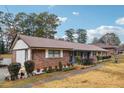 Brick ranch home with carport and landscaped yard at 747 Bethesda School Rd, Lawrenceville, GA 30044
