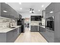 Modern kitchen with sleek gray cabinetry, stainless steel appliances, and tile backsplash at 4125 Crowder Nw Dr, Kennesaw, GA 30152