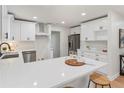 Modern white kitchen with stainless steel appliances and quartz countertops at 2360 Beaver Creek Se Rd, Smyrna, GA 30080