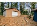 Detached garage with a white door and brown wooden exterior at 1089 Indale Sw Pl, Atlanta, GA 30310