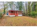 Large backyard with a red porch and shed at 1962 Pine Oak Sw Dr, Atlanta, GA 30310