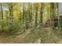 Wooded backyard with stairs leading to deck at 1496 Meadowlark Dr, Decatur, GA 30032