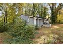 Gray house with wooded backyard and deck at 1496 Meadowlark Dr, Decatur, GA 30032