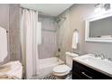 Updated bathroom with grey tile, bathtub and modern vanity at 406 Illinois Nw Ave, Atlanta, GA 30314