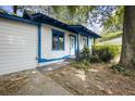 White house with blue trim, showcasing a side view and walkway at 1321 Mcclelland Ave, Atlanta, GA 30344