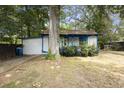 View of the home's side and backyard, showing a tree and fence at 1321 Mcclelland Ave, Atlanta, GA 30344