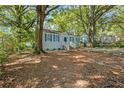 Cute blue house with a large yard and mature trees at 1324 Almont Sw Dr, Atlanta, GA 30310