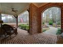 Inviting front porch with brick flooring and a rocking chair at 304 Woodstock Seven Dr, Woodstock, GA 30188