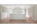 Large walk-in closet with center island, custom built-ins and ample storage at 816 Hillwood Dr, Marietta, GA 30068