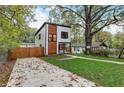 Modern home with a spacious backyard, concrete patio, and mature trees at 1930 Pinedale Nw Dr, Atlanta, GA 30314