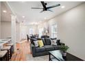 Open living room with hardwood floors, gray sofas, and a ceiling fan at 1930 Pinedale Nw Dr, Atlanta, GA 30314