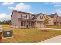 Two-story house with front porch and partial view of community at 1621 Fuma Leaf Way, Mcdonough, GA 30253