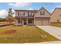 Two-story brick home with a two car garage and mature tree at 1621 Fuma Leaf Way, Mcdonough, GA 30253