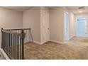 Upstairs hallway with carpet, railing, and doors to bedrooms at 1621 Fuma Leaf Way, Mcdonough, GA 30253
