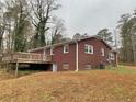 Red brick home with deck and large backyard at 2467 Shady Grove Rd, Carrollton, GA 30116