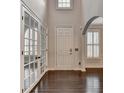 Two-story foyer with hardwood floors, white doors, and plantation shutters at 5530 Highland Preserve Dr, Mableton, GA 30126