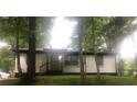 White brick ranch home nestled among lush green trees at 3426 Treadwell Sw Cir, Atlanta, GA 30331