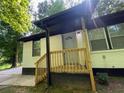 Front view of charming ranch home with light blue door and wood stairs at 3426 Treadwell Sw Cir, Atlanta, GA 30331