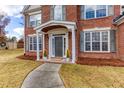 Front view of a brick home's covered entryway with decorative plants and a walkway at 1246 Penncross Way, Marietta, GA 30067