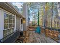Wooden back deck with seating and wooded backyard view at 242 Viola Dr, Dallas, GA 30157