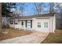 Charming ranch home with a front yard and driveway at 6979 Bruce Cir, Lithonia, GA 30058