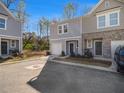 Two-story townhome exterior with driveway parking and a small front yard at 2680 Senegal Way # 88, Atlanta, GA 30331