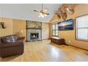 Spacious living room with a fireplace, hardwood floors, and mounted TV at 3185 Tia Nw Ct, Kennesaw, GA 30152