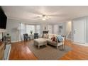 Inviting living room with hardwood floors, a cozy fireplace, and ample natural light at 6918 Clearlake Ct, Peachtree Corners, GA 30360