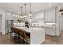 Modern kitchen with white cabinets, large island, and stainless steel appliances at 336 Mont Harmony Sw Rd, Powder Springs, GA 30127
