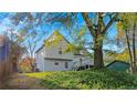 Two-story home with back deck, lush landscaping, and mature trees at 1077 Mainstreet Valley Dr, Stone Mountain, GA 30088