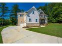 Side view of a house with mixed siding and a concrete driveway at 119 Terrace View Dr, Acworth, GA 30101