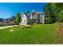 Two-story farmhouse-style home with landscaped yard and driveway at 119 Terrace View Dr, Acworth, GA 30101