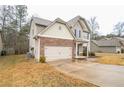 Two-story house with stone accents and a two-car garage at 2534 Grayton Loop, Villa Rica, GA 30180