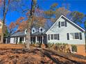 Inviting two-story home with gray siding and white trim on a bright day at 5023 Vernon Oaks Dr, Atlanta, GA 30338