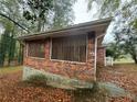 Brick exterior with a covered patio area, showcasing the home's side at 1970 Rena Sw Cir, Atlanta, GA 30311