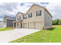 Two-story house, side view, light brick exterior, three-car garage, and landscaped lawn at 311 Bianca Way, Mcdonough, GA 30253