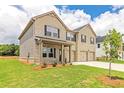 Two-story house, side view, light brick exterior, three-car garage, and landscaping at 311 Bianca Way, Mcdonough, GA 30253