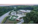 An aerial view of a community park with playground, surrounded by lush trees at 687 Summitt Hill Way, Cumming, GA 30040