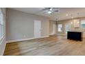 Open-concept living area with wood-look flooring and modern light fixtures at 4230 Moore Rd, Conley, GA 30288