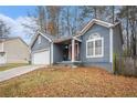 Two-story home with a covered porch, attached garage, and front yard at 2291 Wilkins Ct, Decatur, GA 30035