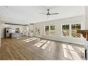 Open concept living room and kitchen with wood floors and large windows at 5272 Poplar Springs Rd, Stone Mountain, GA 30083