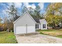 Gray house with two-car garage and large yard at 1299 Paddocks Way, Powder Springs, GA 30127