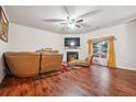 Spacious living room with fireplace, hardwood floors, and ample natural light at 60 Silver Willow Ct, Covington, GA 30016